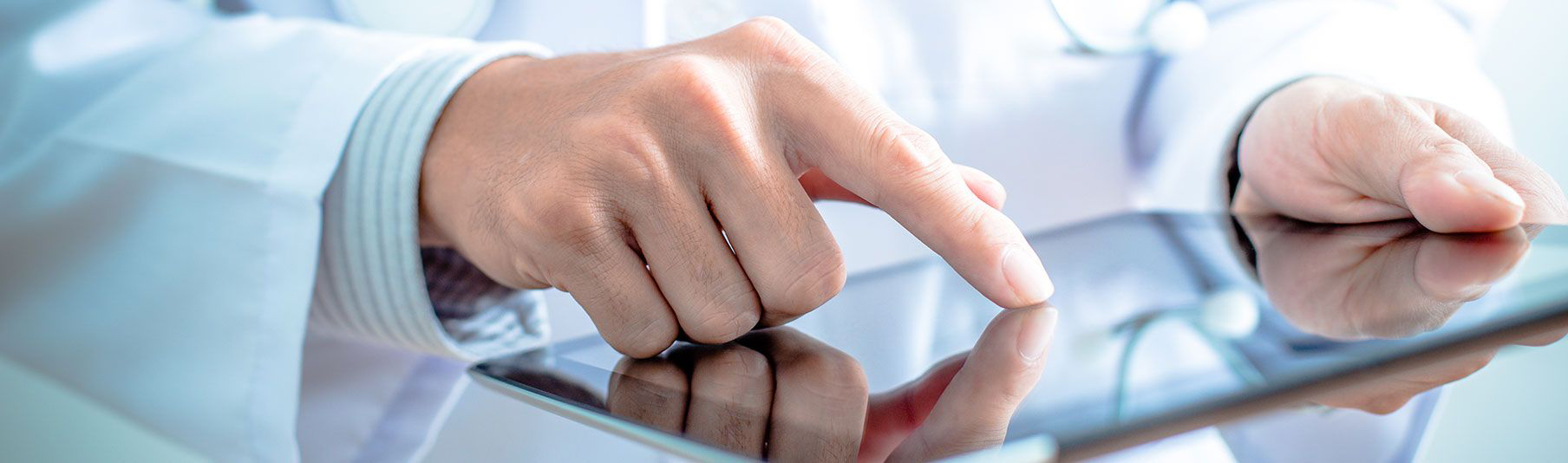 Key Locum Insurance Covers: Close-up of a doctor's hand using a tablet